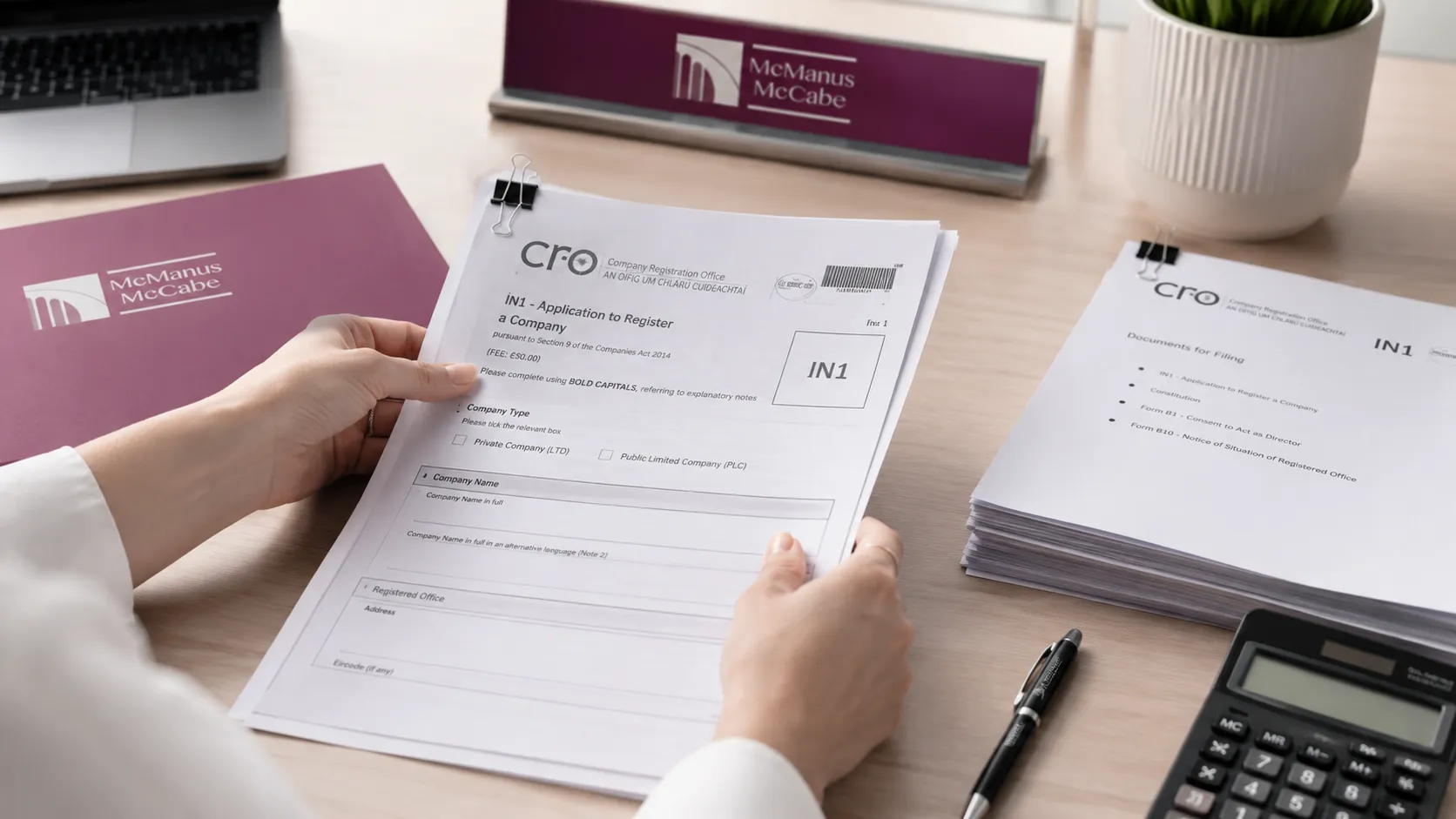 A close-up of Companies Registration Office CRO incorporation forms being organised for a new limited company startup in Ireland.